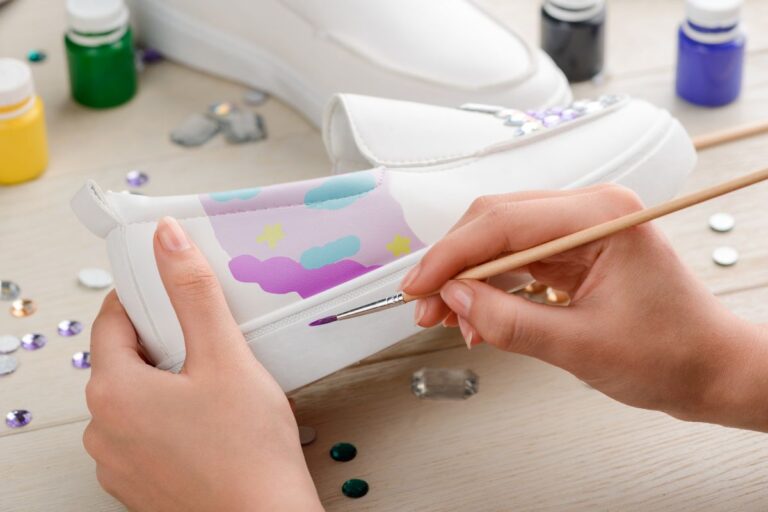 A lady customizing her shoe by painting on it