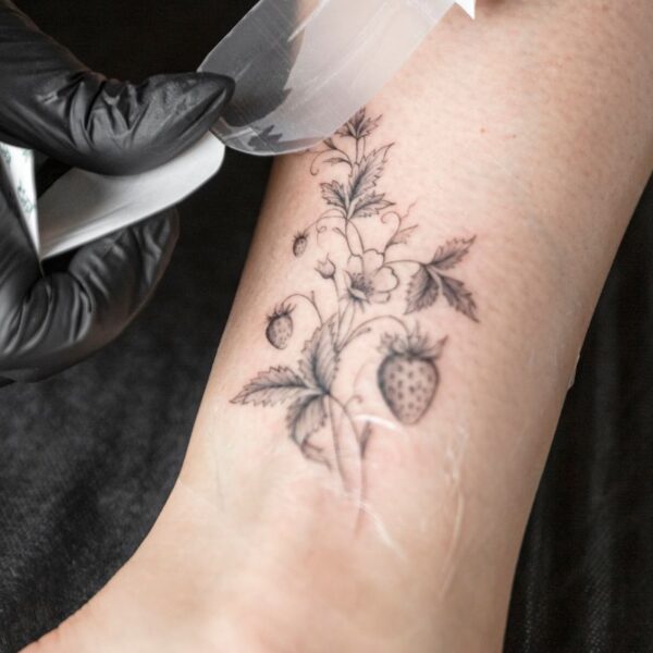 A lady getting stick on temporary tattoo