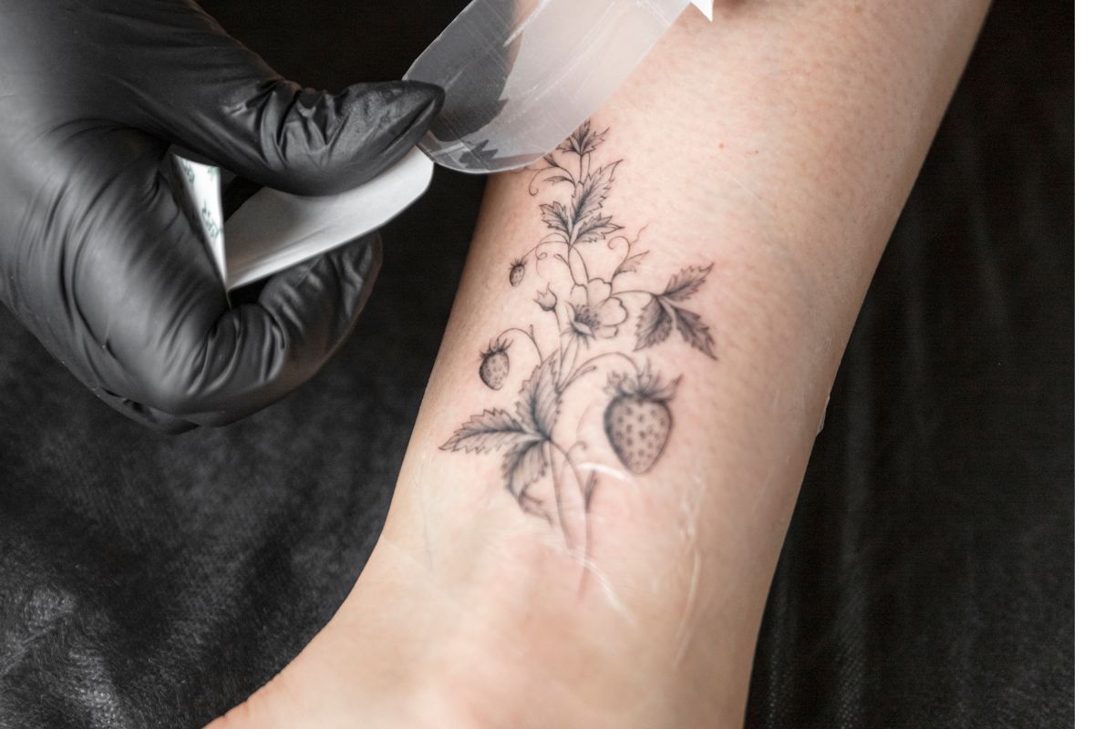 A lady getting stick on temporary tattoo