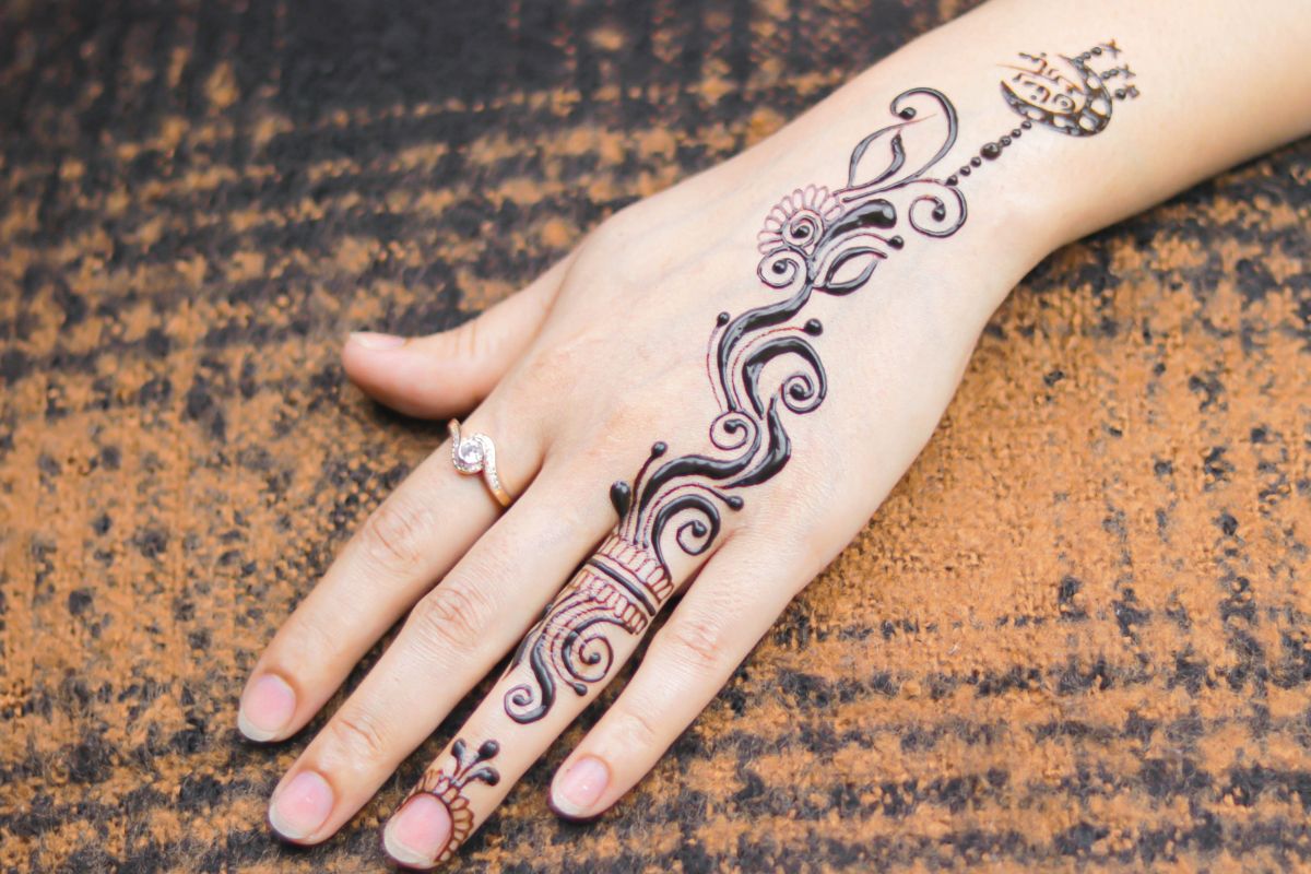 A lady having temporary tattoo on her hand