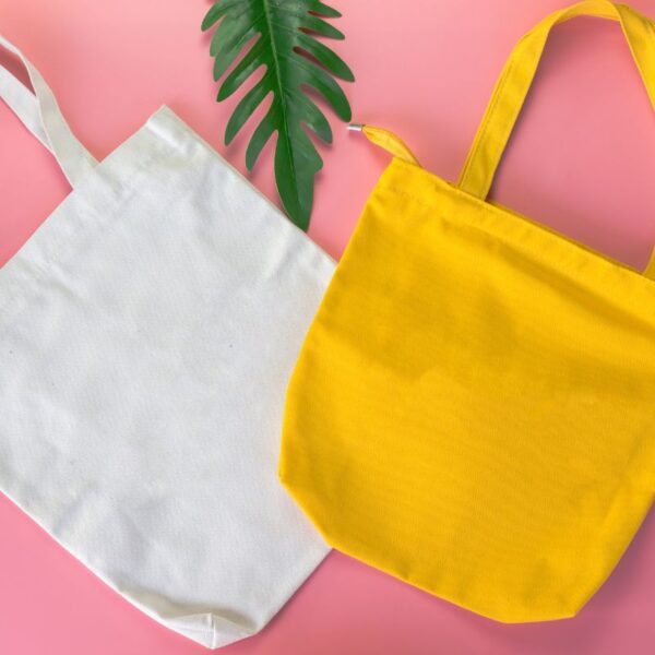 Two different colored custom tote bag kept with each other