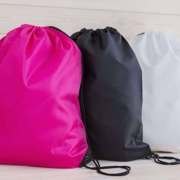 A collection of three different custom drawstring bags shown in the image
