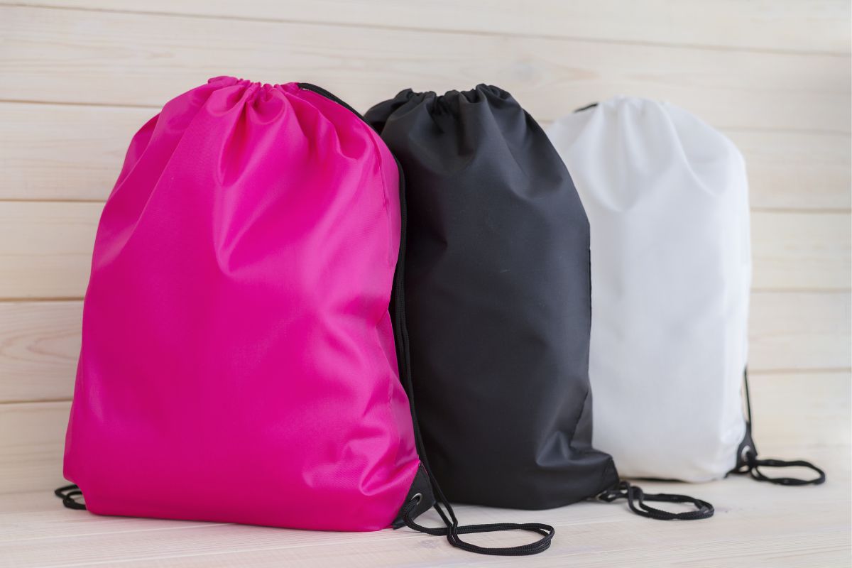 A collection of three different custom drawstring bags shown in the image