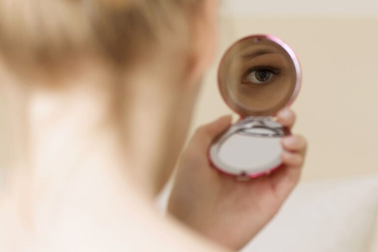 A lady watching herself on the custom mirror