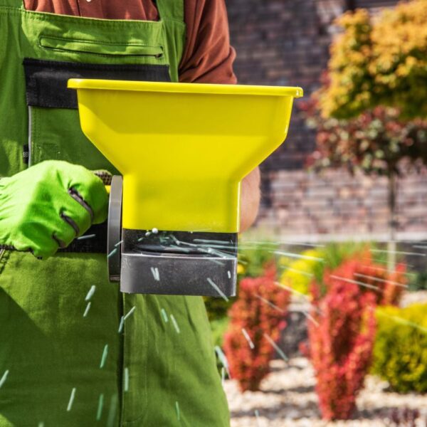 A person is using a custom lawn and gardening product