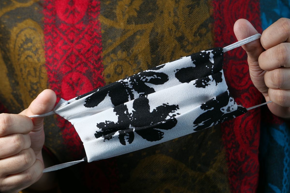 A person showing his custom designed facemask