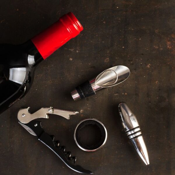 A bottle of wine kept with some wine accessories