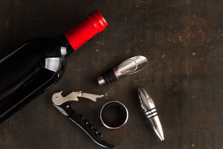 A bottle of wine kept with some wine accessories