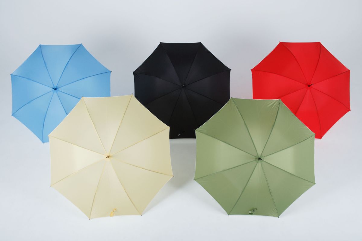 A collection of different colored custom umbrellas ready for personalization