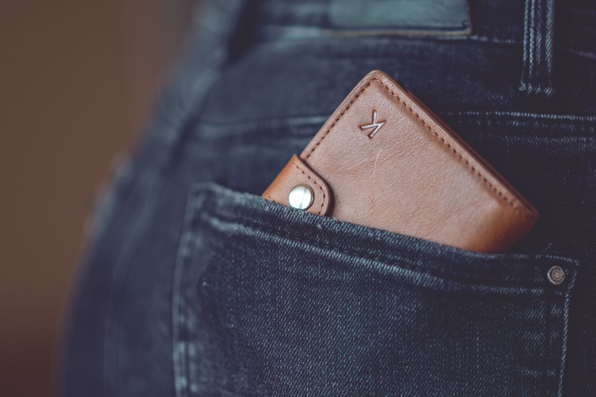 A custom wallet with an engraved letter tucked into a pocket