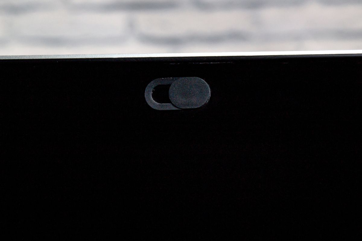 A custom webcam cover is attached to the laptop