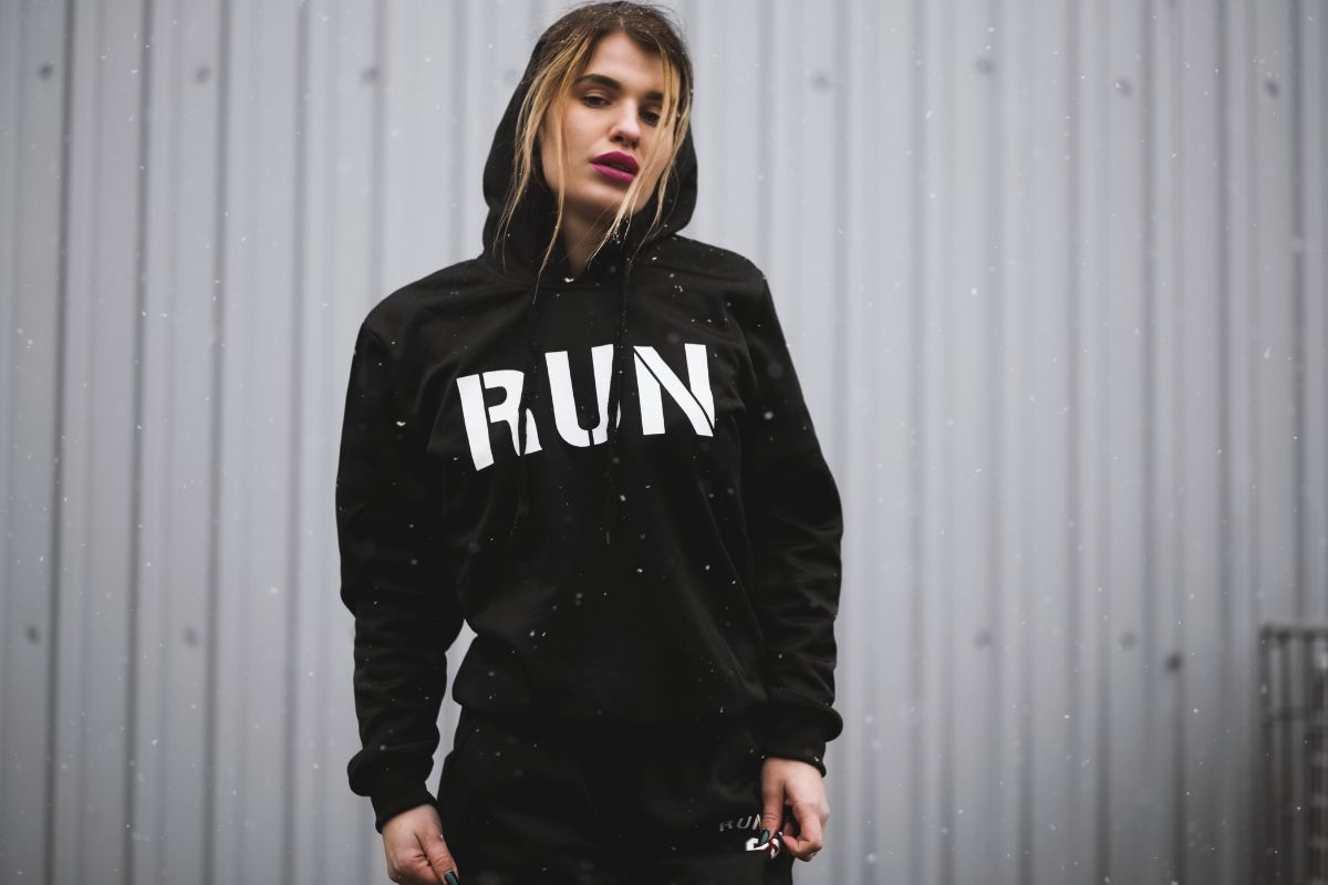 A fitness loving woman wearing a custom printed hoodie