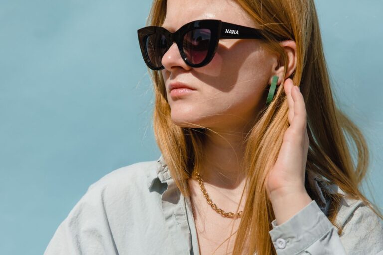 A lady wearing custom sunglasses with her name printed on it