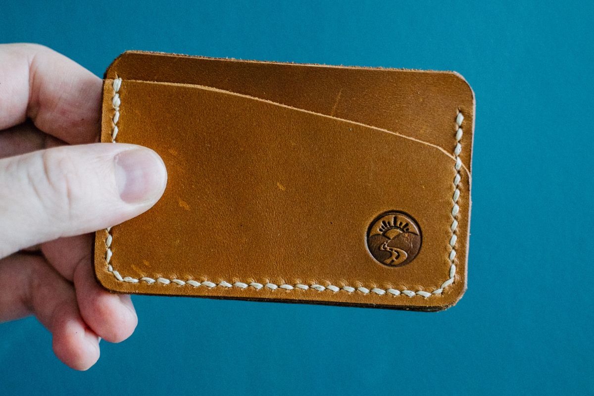 A person holding a custom wallet