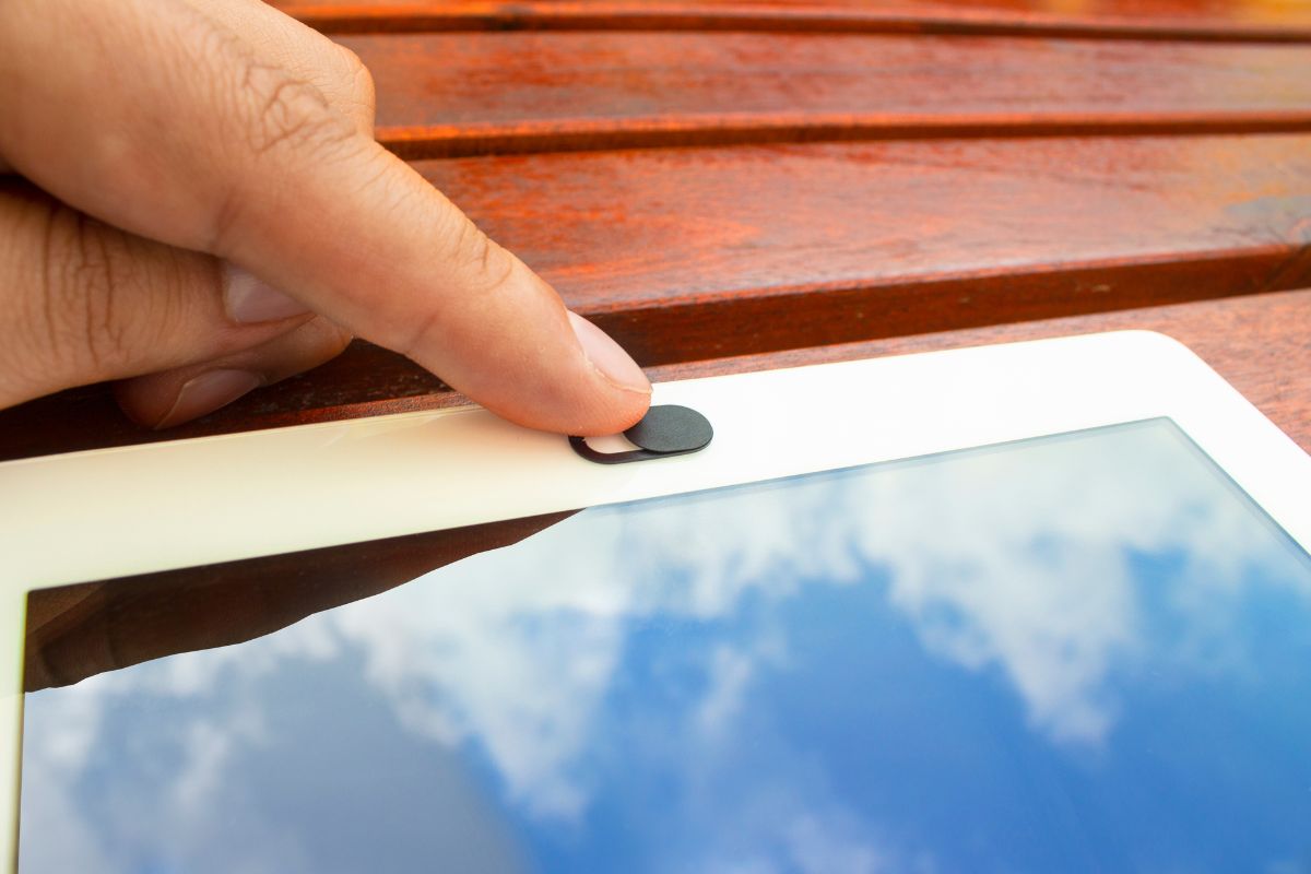 A person using custom webcam cover for his tablet