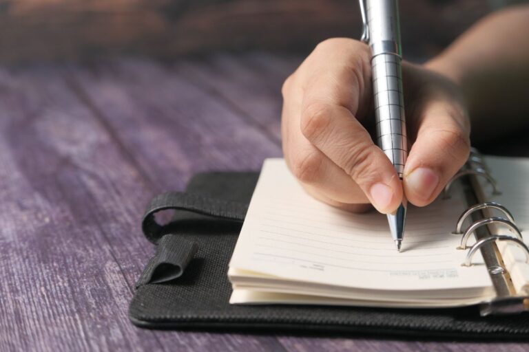 A person writing on a custom padfolio