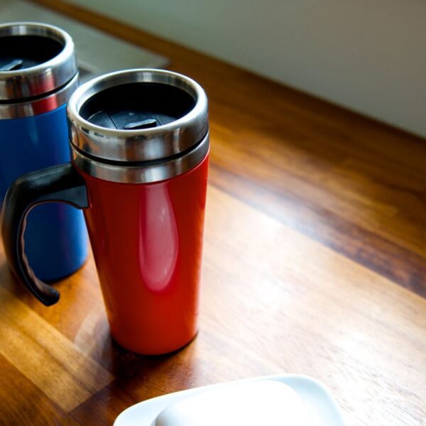 Two custom tumblers are kept on a table