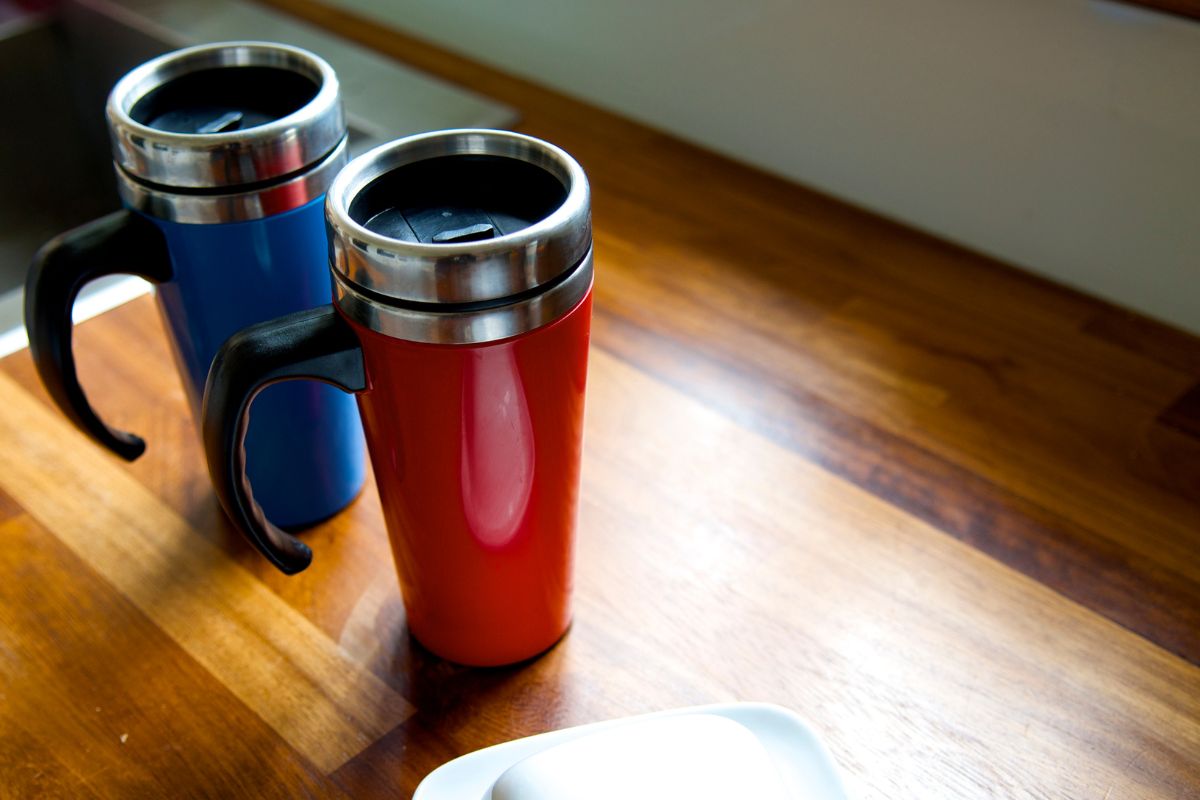 Two custom tumblers are kept on a table