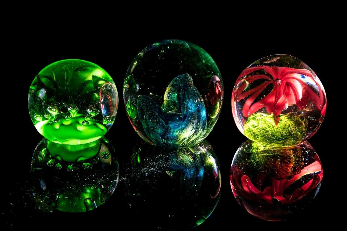 A collection of different colored custom paperweights kept with each other