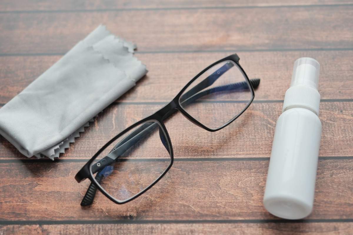A custom cleaning cloth is placed with spectacles and their cleaner