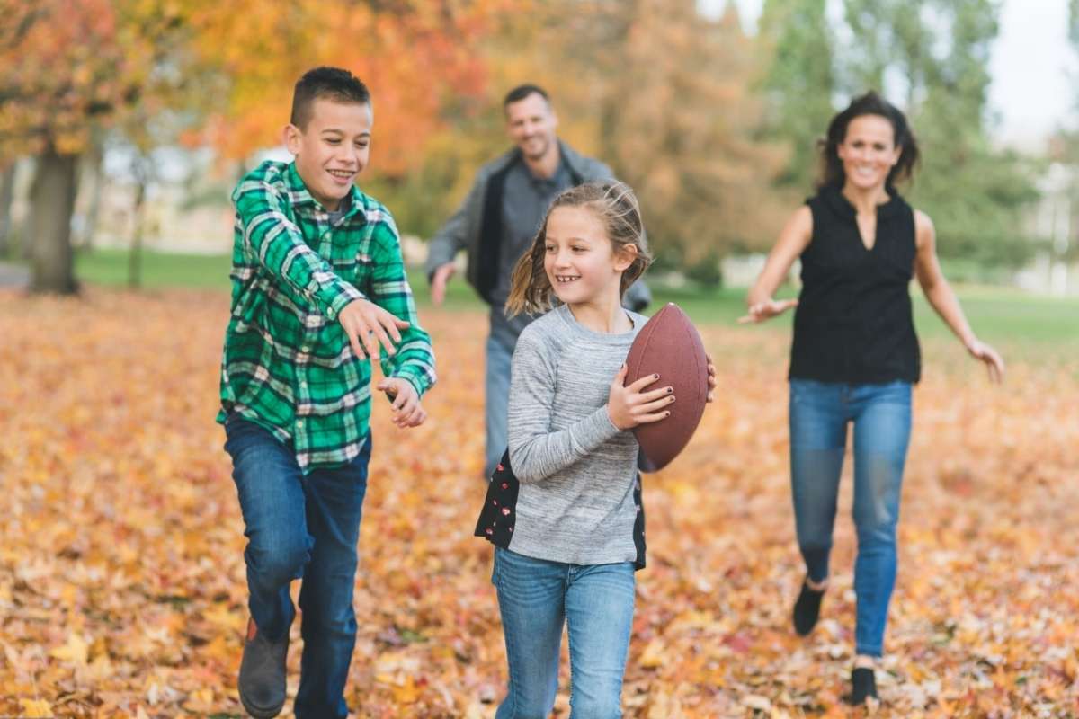 A family is playing with a custom football together