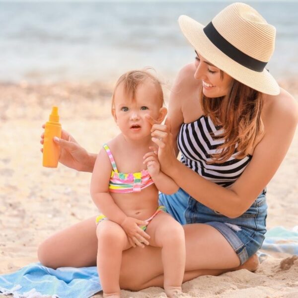 A lady applying custom sunscreen to her baby