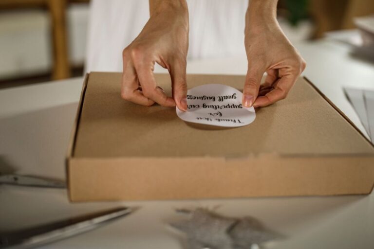 A lady pasting a custom sticker on her products to thank customers