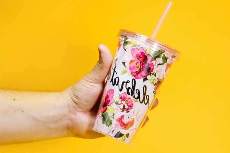 A person holding a printed custom travel tumbler