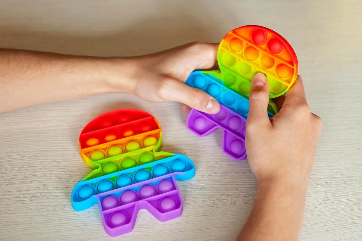 A person squeezing a stress reliever toy for relaxation