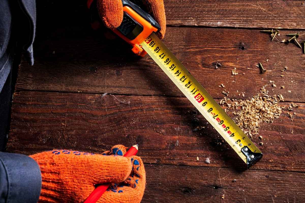 A person using a custom tape measure on a construction site