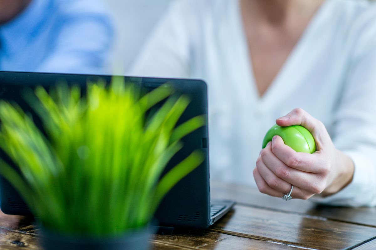 An executive using a stress ball to get relief from work
