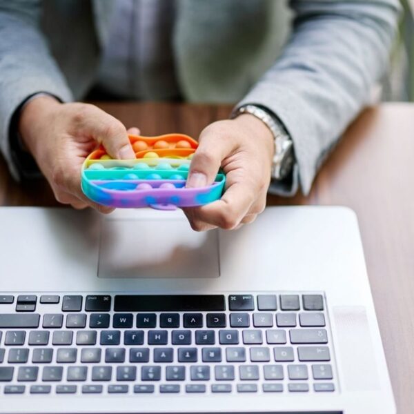 An office employee playing with a stress reliever toy in his free time