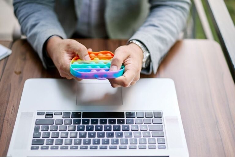 An office employee playing with a stress reliever toy in his free time