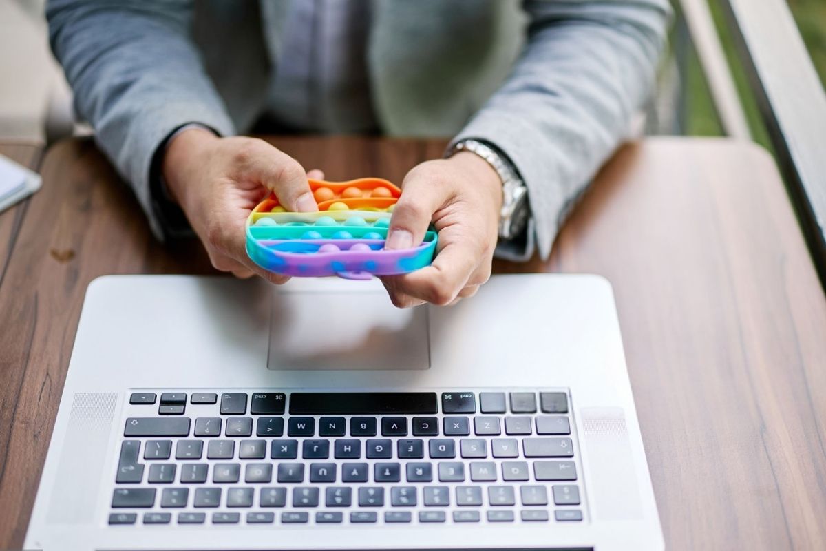 An office employee playing with a stress reliever toy in his free time