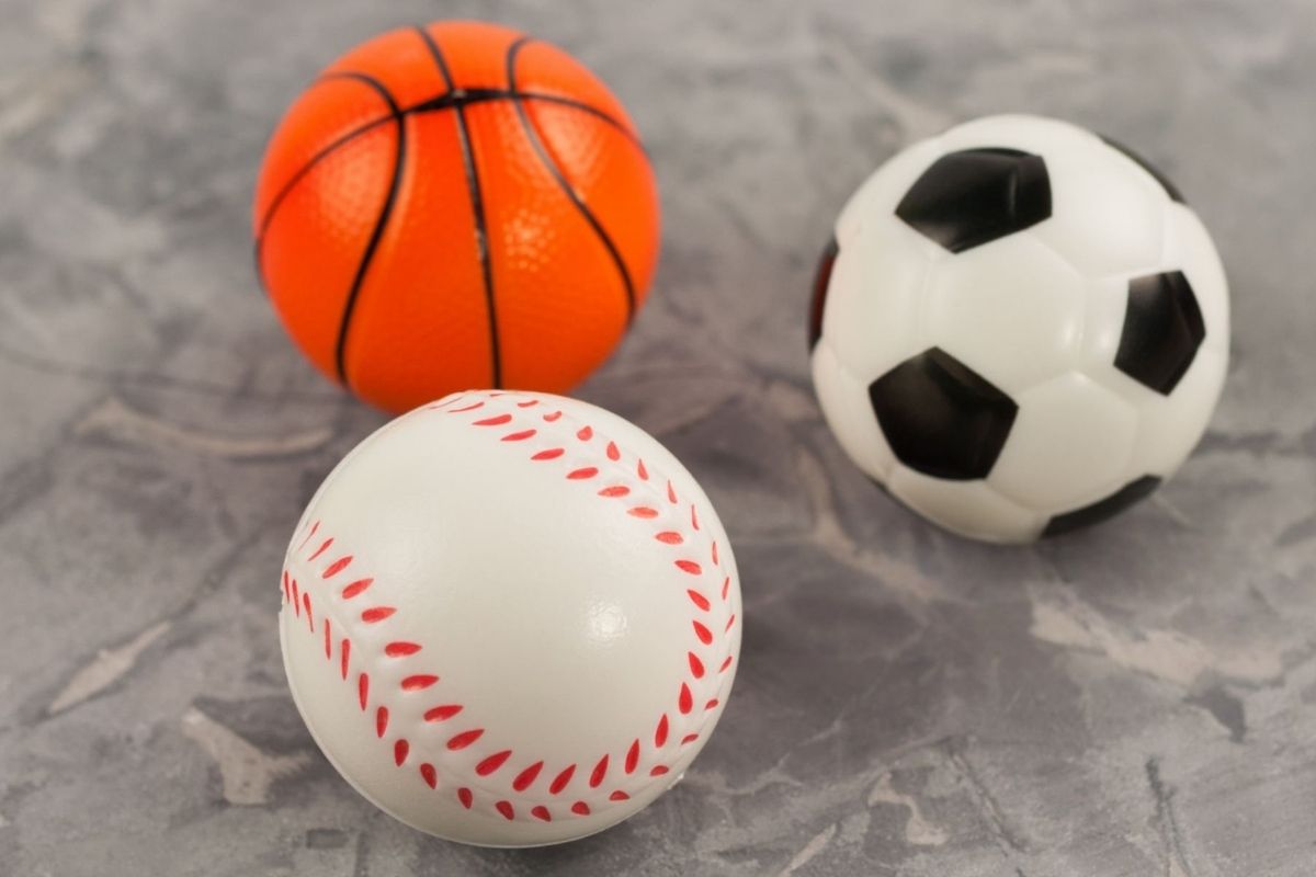 Three different custom stress reliever sports balls placed together