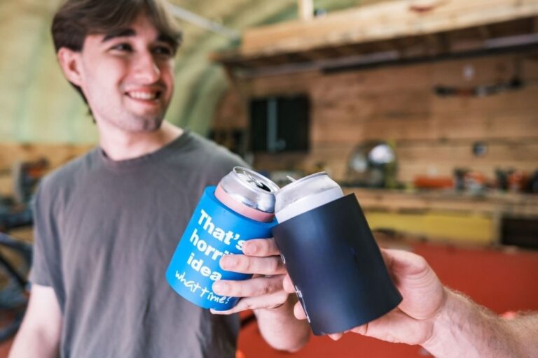Two friends are drinking their drinks using can coolers