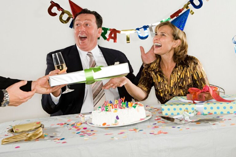 An employee receiving retirement gifts from his colleague.