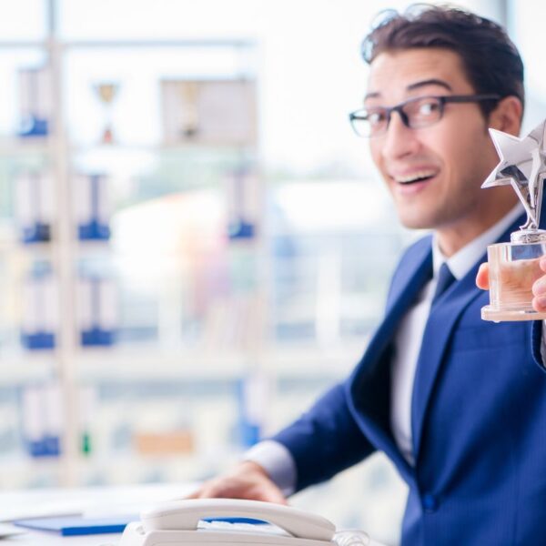 An employee showing his star performer of the year award