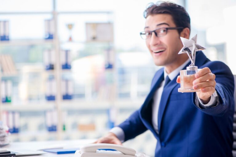 An employee showing his star performer of the year award